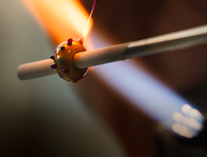 A Trollbeads glass bead in the making in a hot flame.